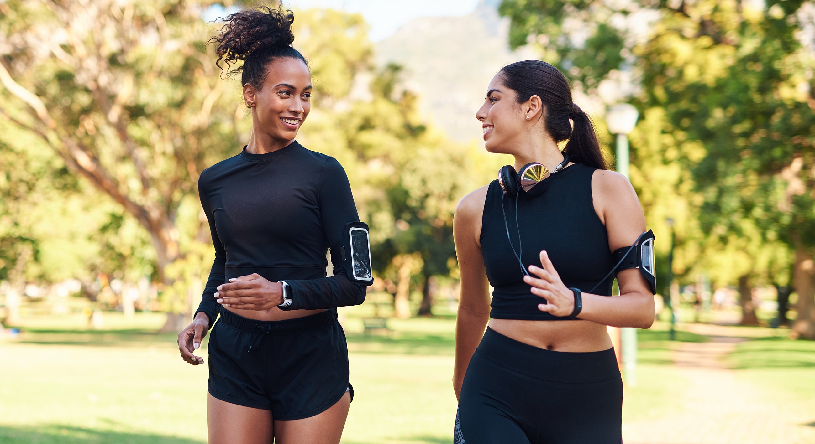 Two women jogging together in a park.